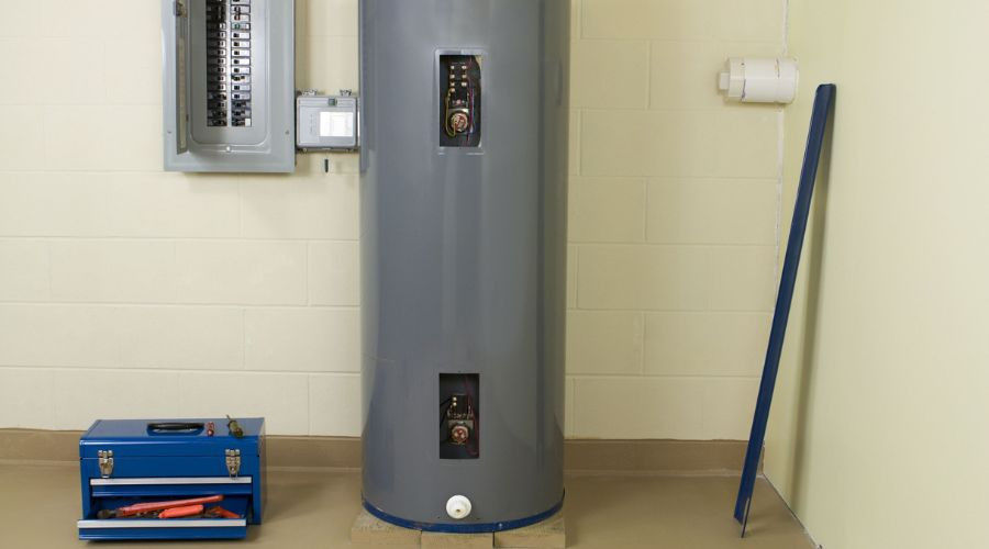 Water heater and electrical panel in a clean, organized space for plumbing maintenance by Guardian Plumbing and Drain.